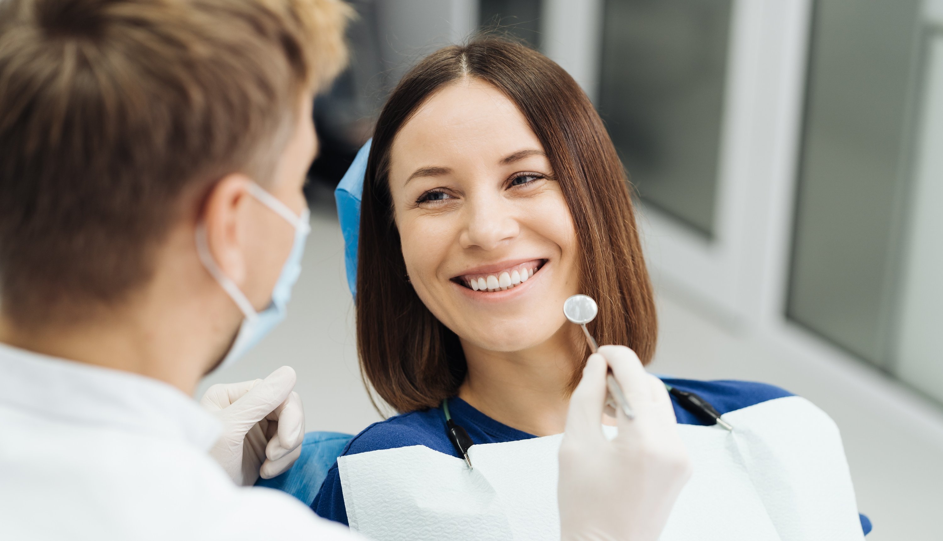 male-professional-dentist-with-gloves-mask-discuss-what-treatment-will-look-like-patient-s-teeth